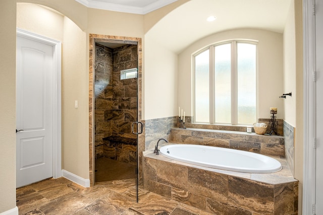 full bathroom featuring a bath, a shower stall, and crown molding