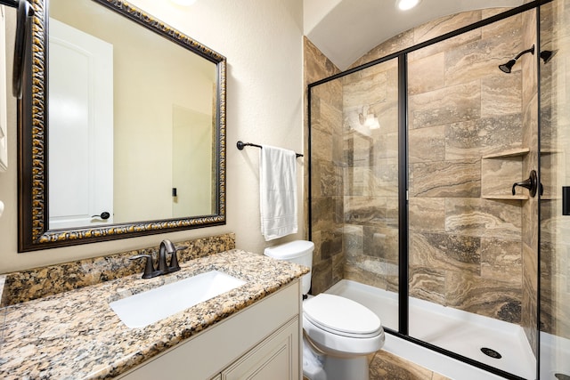 full bathroom with a stall shower, toilet, and vanity