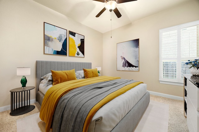 carpeted bedroom with baseboards and ceiling fan