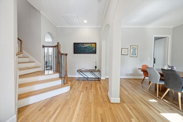 4005 Gramercy St, Houston, TX 77025 - staircase with arched walkways, crown molding, wood finished floors, baseboards, and recessed lighting