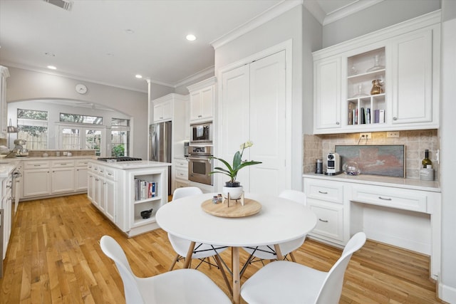 4005 Gramercy St, Houston, TX 77025 - kitchen featuring open shelves, appliances with stainless steel finishes, crown molding, white cabinetry, and tasteful backsplash