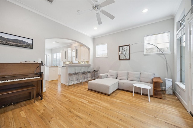 4005 Gramercy St, Houston, TX 77025 - living room with arched walkways, ornamental molding, ceiling fan, light wood-style floors, and recessed lighting