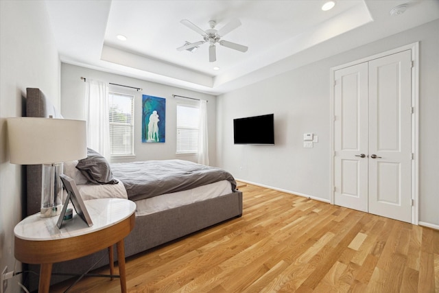4005 Gramercy St, Houston, TX 77025 - bedroom with a raised ceiling, light wood-style floors, recessed lighting, a ceiling fan, and a closet