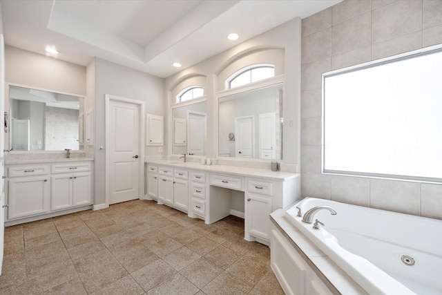 4005 Gramercy St, Houston, TX 77025 - full bathroom featuring healthy amount of natural light, a tub with jets, vanity, and recessed lighting