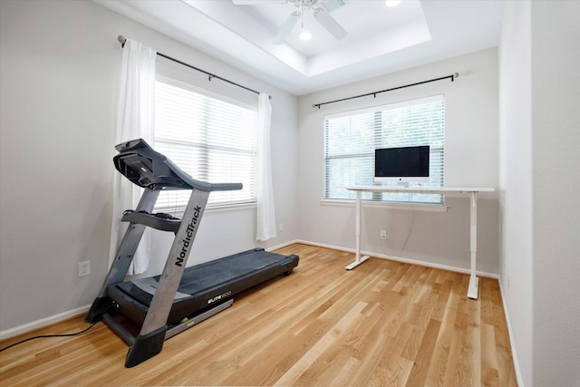 4005 Gramercy St, Houston, TX 77025 - exercise room featuring wood finished floors, a raised ceiling, baseboards, and a ceiling fan