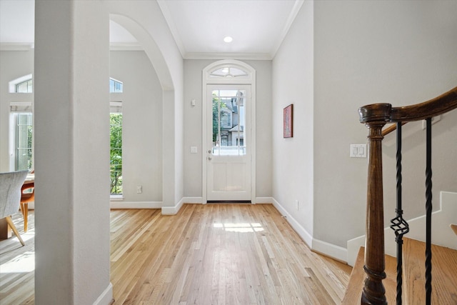 4005 Gramercy St, Houston, TX 77025 - entrance foyer featuring arched walkways, healthy amount of natural light, light wood-style floors, ornamental molding, and baseboards