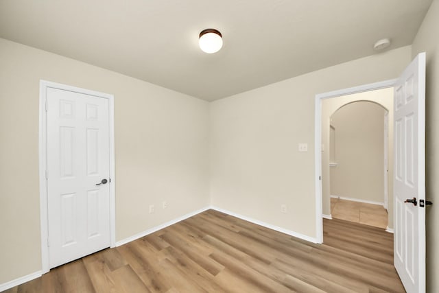 2614 Leopard Ct, Katy, TX 77449 - empty room with wood finished floors, baseboards, and a smoke detector
