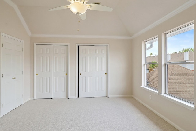 1383 El Camino Village Dr, Webster, TX 77058 - unfurnished bedroom with vaulted ceiling, multiple closets, ornamental molding, carpet floors, and baseboards
