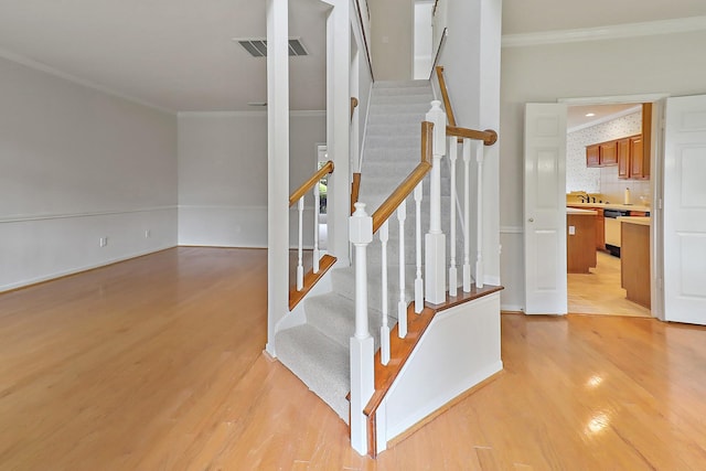 1383 El Camino Village Dr, Webster, TX 77058 - stairway with ornamental molding and wood finished floors