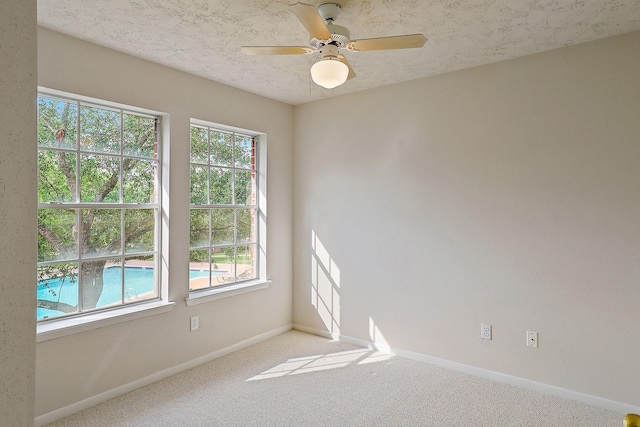 1383 El Camino Village Dr, Webster, TX 77058 - carpeted empty room featuring healthy amount of natural light, baseboards, and a ceiling fan