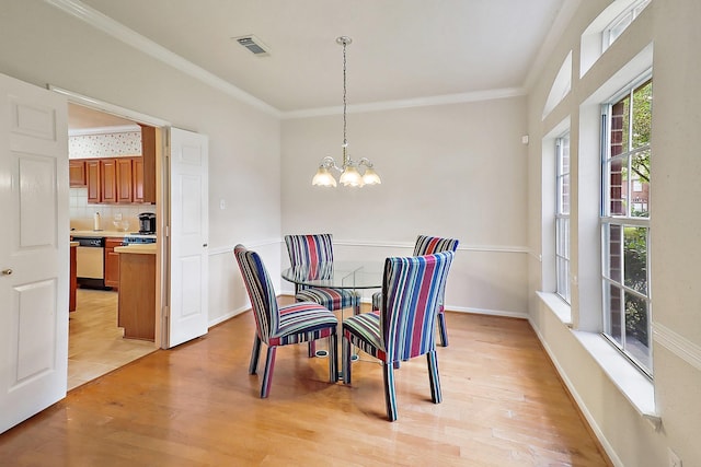 1383 El Camino Village Dr, Webster, TX 77058 - dining space featuring light wood finished floors, a chandelier, and ornamental molding