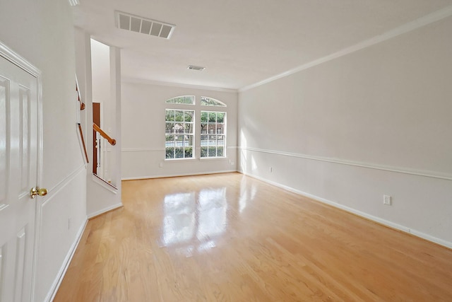 1383 El Camino Village Dr, Webster, TX 77058 - empty room featuring stairway, wood finished floors, baseboards, and crown molding