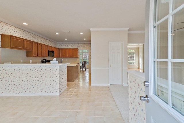 1383 El Camino Village Dr, Webster, TX 77058 - kitchen with black microwave, crown molding, light countertops, brown cabinetry, and light tile patterned floors