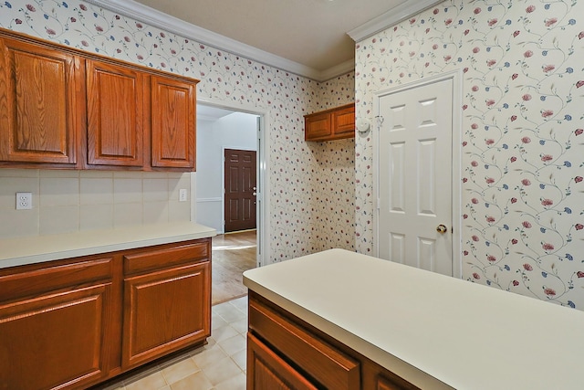 1383 El Camino Village Dr, Webster, TX 77058 - kitchen with ornamental molding, wallpapered walls, light countertops, brown cabinetry, and backsplash