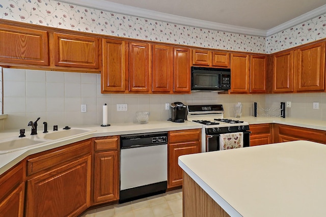 1383 El Camino Village Dr, Webster, TX 77058 - kitchen featuring black microwave, range with gas cooktop, stainless steel dishwasher, a sink, and wallpapered walls