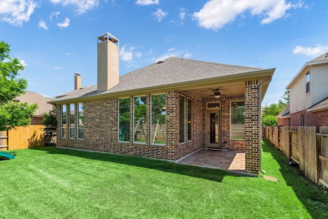 28437 Ofallon Mills Dr, Spring, TX 77386 - rear view of house featuring a ceiling fan, brick siding, a chimney, a patio, and roof with shingles