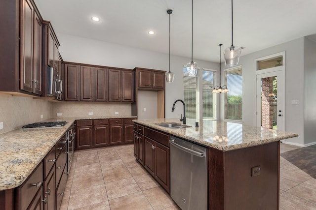 28437 Ofallon Mills Dr, Spring, TX 77386 - kitchen with a sink, appliances with stainless steel finishes, light tile patterned flooring, decorative backsplash, and dark brown cabinets