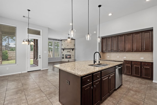28437 Ofallon Mills Dr, Spring, TX 77386 - kitchen featuring a sink, stainless steel dishwasher, light tile patterned floors, a fireplace, and recessed lighting
