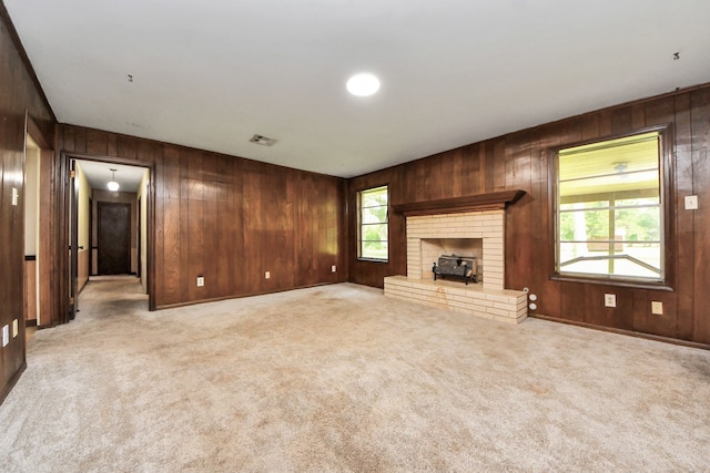 1417 Brigance Rd, Brazoria, TX 77422 - unfurnished living room featuring wood walls and carpet floors
