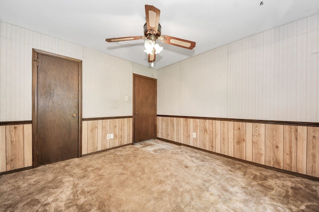 1417 Brigance Rd, Brazoria, TX 77422 - carpeted spare room featuring ceiling fan, baseboards, wood walls, and wallpapered walls