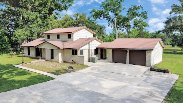 1417 Brigance Rd, Brazoria, TX 77422 - view of front facade with brick siding, central AC, concrete driveway, a front yard, and a garage