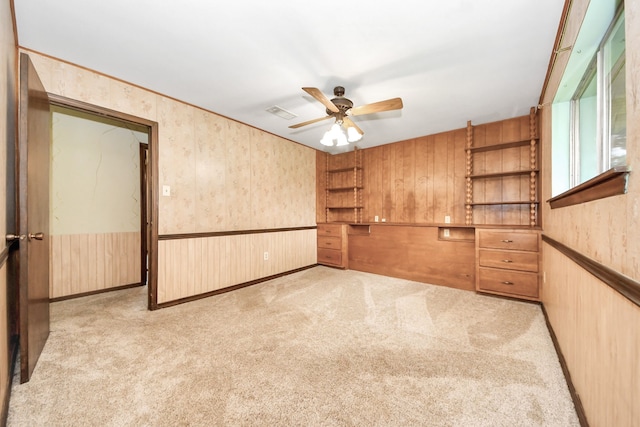 1417 Brigance Rd, Brazoria, TX 77422 - empty room with ceiling fan, carpet floors, and wooden walls