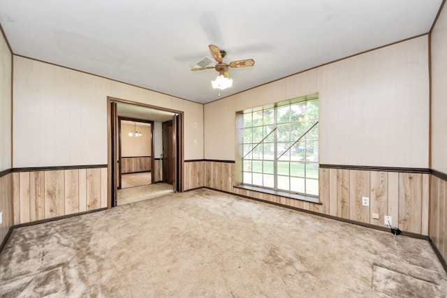 1417 Brigance Rd, Brazoria, TX 77422 - carpeted spare room featuring wood walls, ceiling fan, and a wainscoted wall