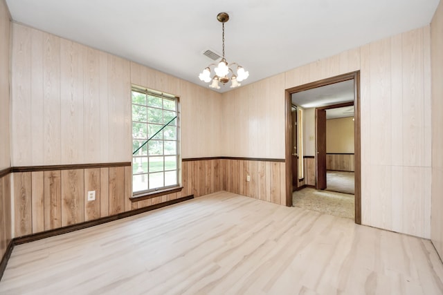 1417 Brigance Rd, Brazoria, TX 77422 - empty room with a chandelier, wood walls, and wainscoting