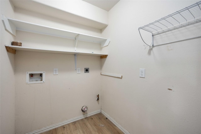 2814 Dustin Place Ct, Humble, TX 77396 - laundry room with light wood-style floors, electric dryer hookup, washer hookup, baseboards, and gas dryer hookup