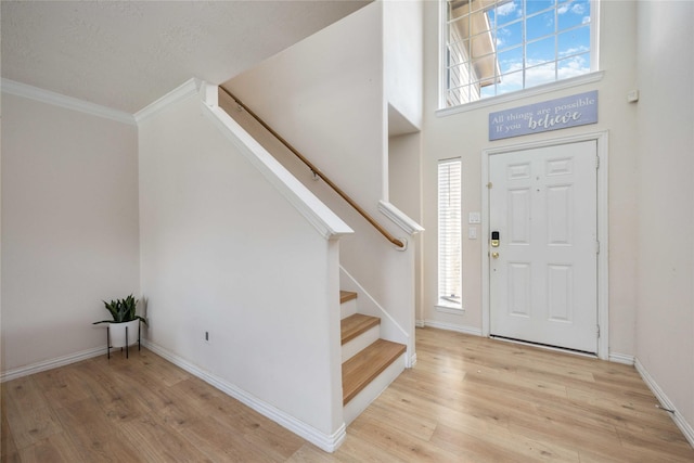 2814 Dustin Place Ct, Humble, TX 77396 - entrance foyer featuring stairway, crown molding, wood finished floors, baseboards, and plenty of natural light