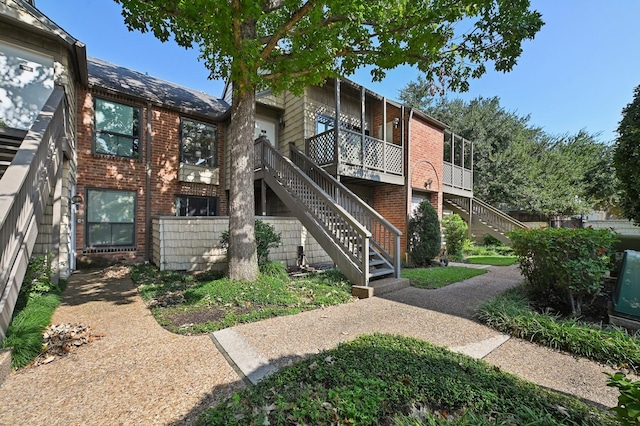 2829 Timmons Ln Unit 184, Houston, TX 77027 - rear view of property with stairs and brick siding