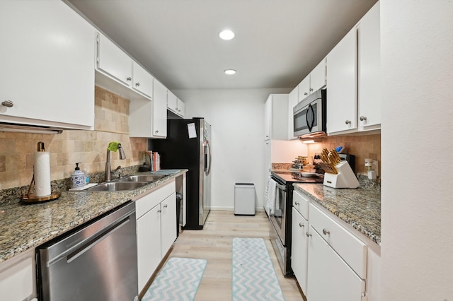 2829 Timmons Ln Unit 184, Houston, TX 77027 - kitchen with stainless steel appliances, a sink, backsplash, recessed lighting, and white cabinets