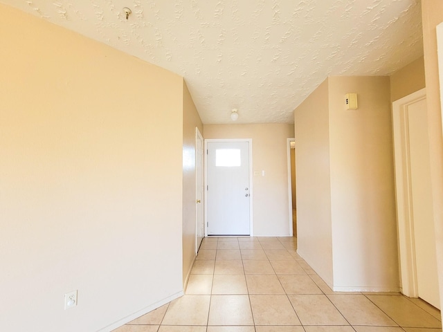 23930 Griffin House Ln, Katy, TX 77493 - hallway featuring light tile patterned floors, baseboards, and a textured ceiling