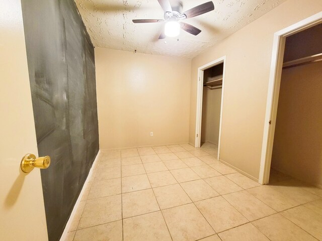 23930 Griffin House Ln, Katy, TX 77493 - unfurnished bedroom featuring light tile patterned flooring, ceiling fan, and a textured ceiling