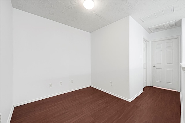 16106 Greenport Ln, Houston, TX 77084 - unfurnished room with dark wood-style flooring, a textured ceiling, and baseboards