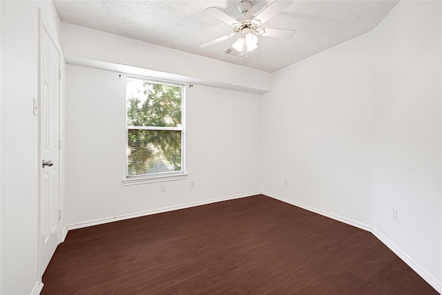 16106 Greenport Ln, Houston, TX 77084 - empty room with dark wood-type flooring, ceiling fan, a textured ceiling, and baseboards