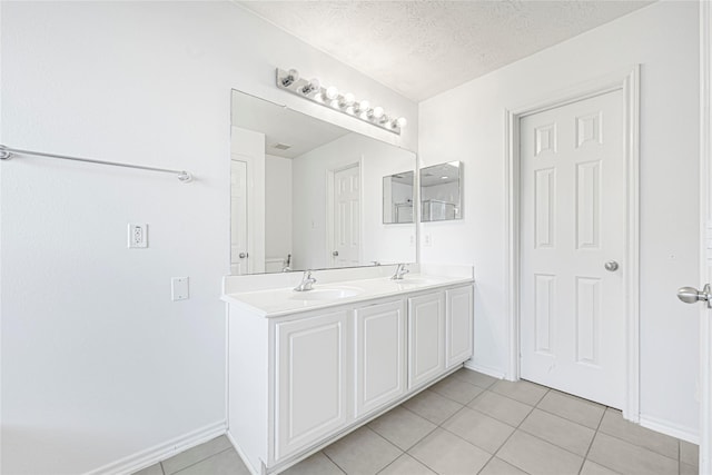 16106 Greenport Ln, Houston, TX 77084 - full bathroom with tile patterned floors, double vanity, baseboards, and a textured ceiling