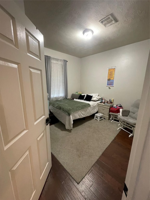 14720 Branchwest Dr, Houston, TX 77082 - bedroom with dark wood finished floors and a textured ceiling