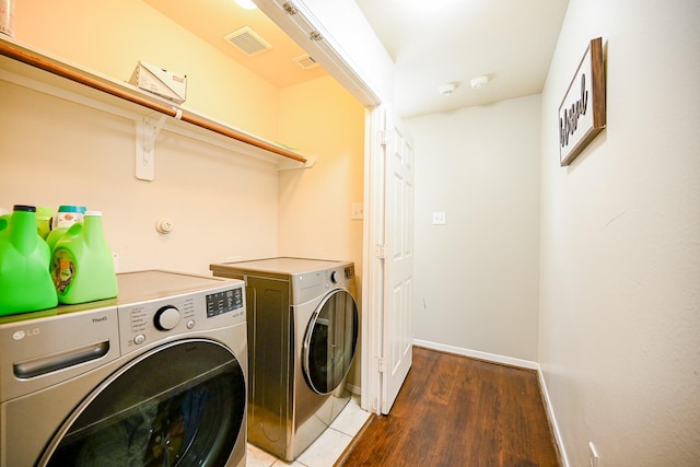 14720 Branchwest Dr, Houston, TX 77082 - laundry room featuring separate washer and dryer, wood finished floors, and baseboards