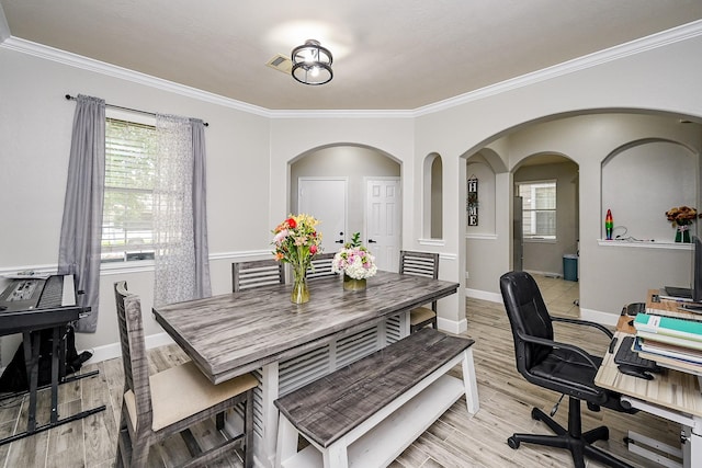 14720 Branchwest Dr, Houston, TX 77082 - dining room featuring light wood-style flooring, ornamental molding, baseboards, a desk, and arched walkways