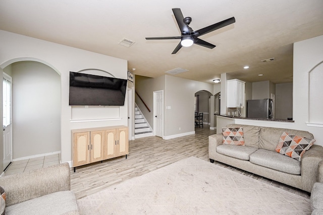 14720 Branchwest Dr, Houston, TX 77082 - living area featuring arched walkways, ceiling fan, light wood-style floors, baseboards, and recessed lighting