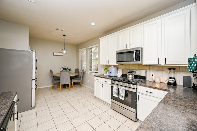 14720 Branchwest Dr, Houston, TX 77082 - kitchen featuring appliances with stainless steel finishes, dark countertops, tasteful backsplash, and recessed lighting