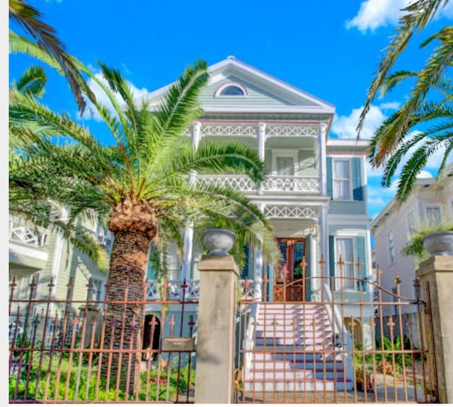 2113 Ball, Galveston, TX 77550 - view of front of house with a balcony, a gate, french doors, and stairs