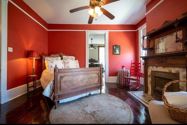 2113 Ball, Galveston, TX 77550 - bedroom featuring hardwood / wood-style floors, baseboards, a stone fireplace, and ceiling fan