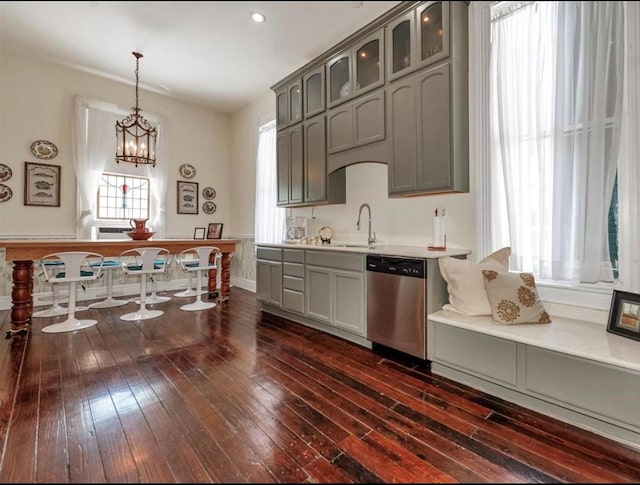 2113 Ball, Galveston, TX 77550 - kitchen with stainless steel dishwasher, a sink, gray cabinetry, dark wood-type flooring, and light countertops