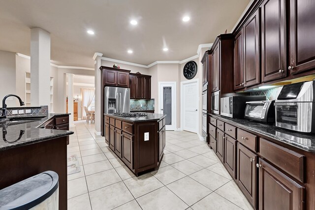 8303 Crescent Knolls Dr, Richmond, TX 77406 - kitchen with a sink, tasteful backsplash, a center island, recessed lighting, and dark stone countertops