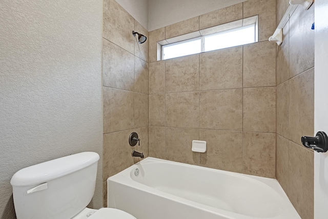 8303 Crescent Knolls Dr, Richmond, TX 77406 - bathroom featuring toilet, bathtub / shower combination, and a textured wall