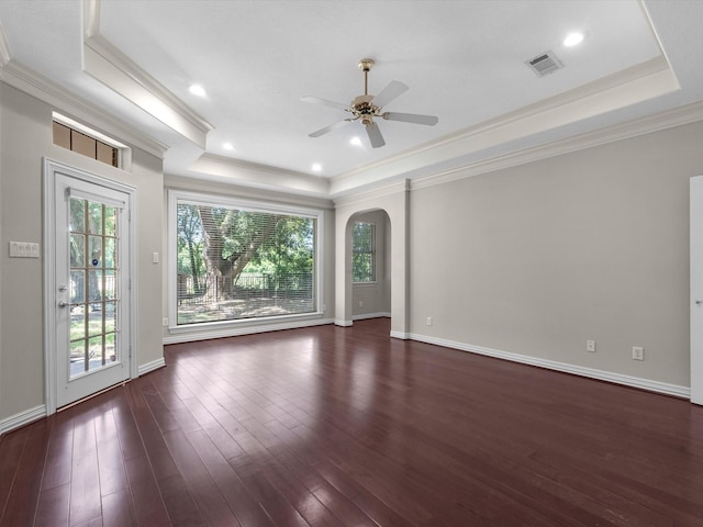 3311 El Dorado Blvd, Missouri City, TX 77459 - empty room with a raised ceiling, ornamental molding, arched walkways, ceiling fan, and dark wood-type flooring