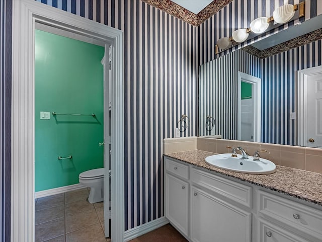 3311 El Dorado Blvd, Missouri City, TX 77459 - bathroom featuring baseboards, toilet, wallpapered walls, tile patterned flooring, and vanity