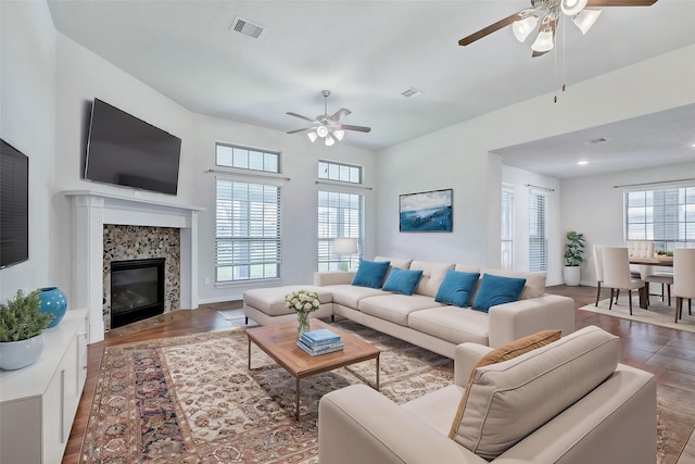 6722 Hawkins St, Manvel, TX 77578 - living area featuring ceiling fan, a fireplace, and wood finished floors